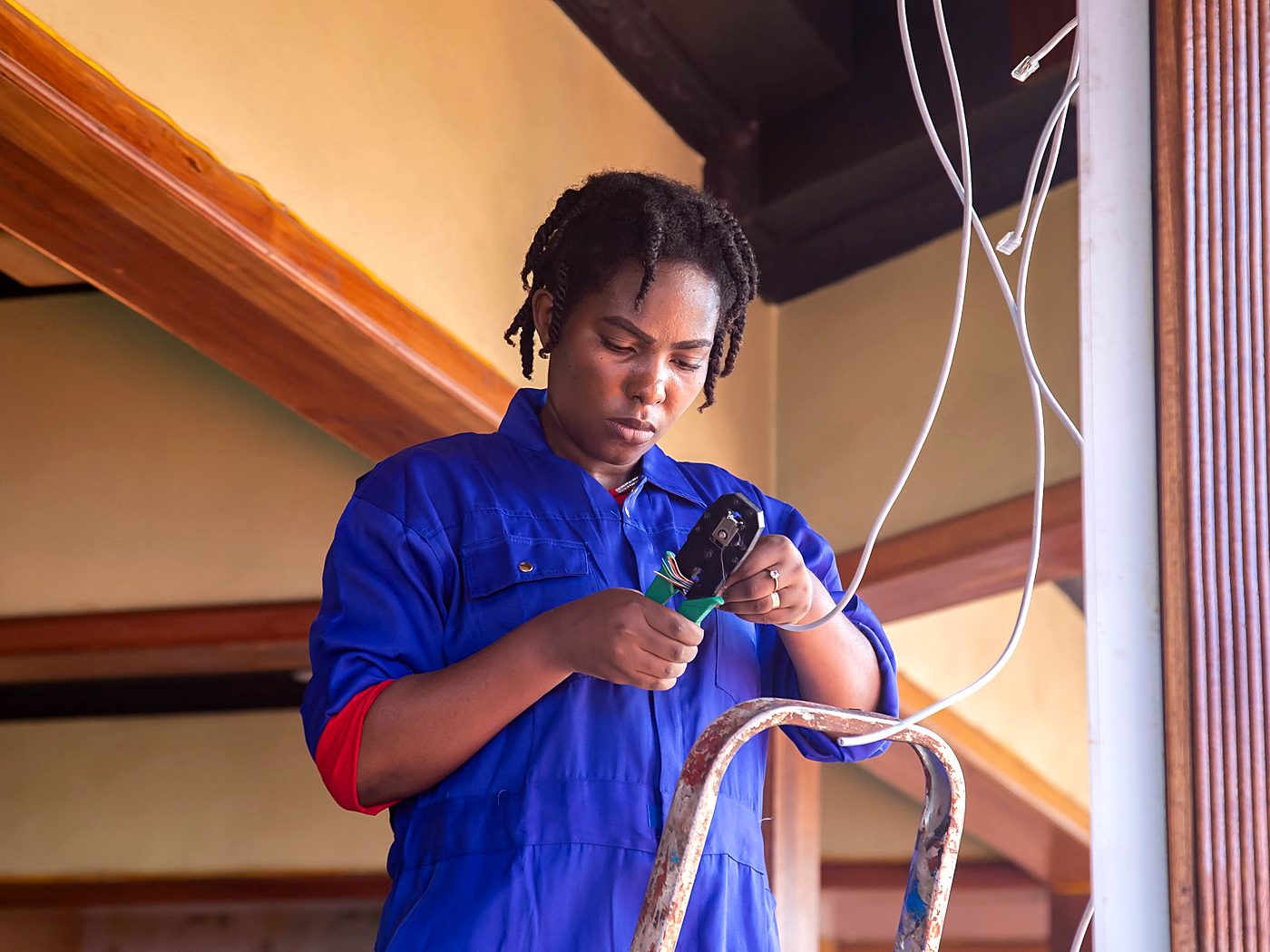 Electrician stripping and terminating data cable during a fit-out